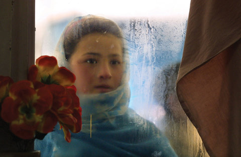 Switan, 10, looked into the window of a Herat restaurant. Kabul, Afghanistan, 2002.