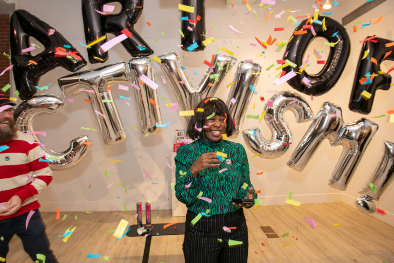 Photo by Christine Butler. The Art of Activism book launch with Steve Lambert surprising Pat Jerido with a confetti canon