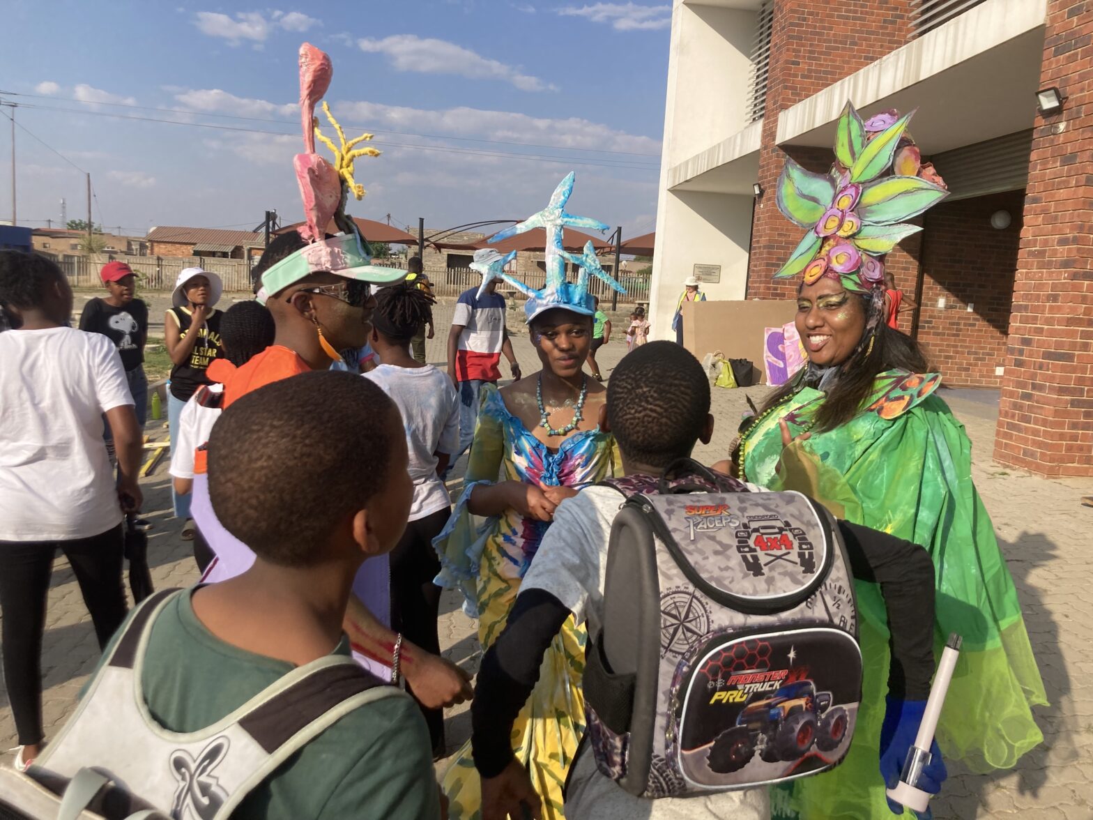 PHOTO activists dressed in colorfully homemade costumes and headdresses talking with students