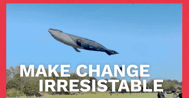PHOTO Make Change Irresistable, Large whale kite floating in sky