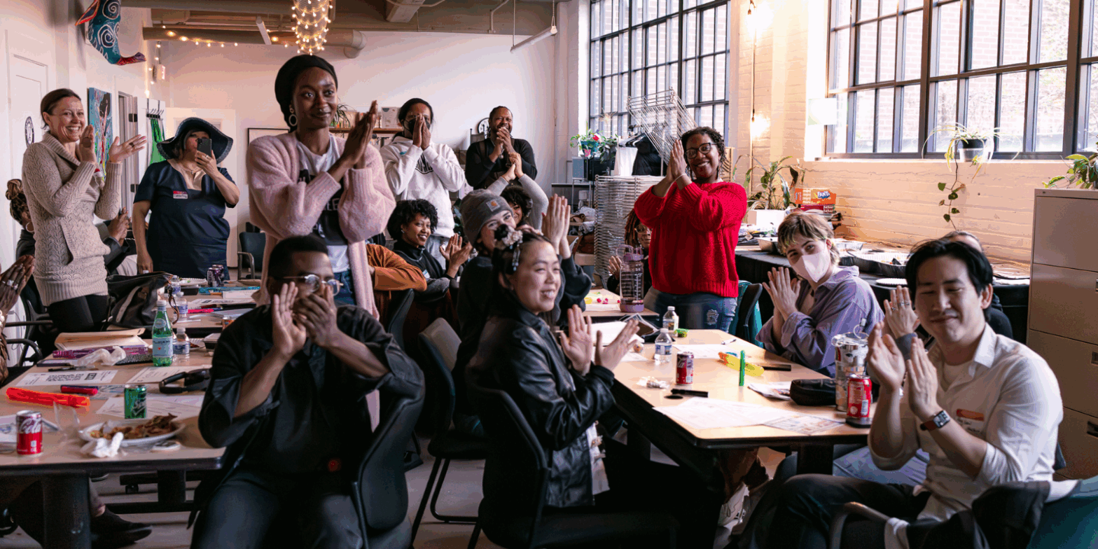 PHOTO from C4AA training, folks sitting and standing while applauding